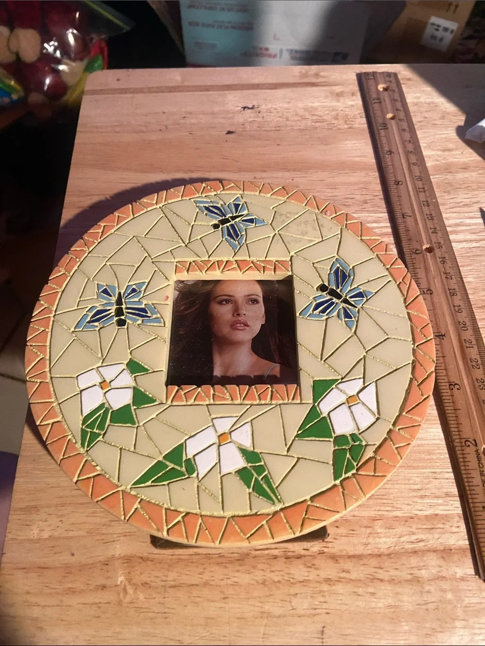 This Vintage Mosaic Style Photo Frame features a cream-colored round design